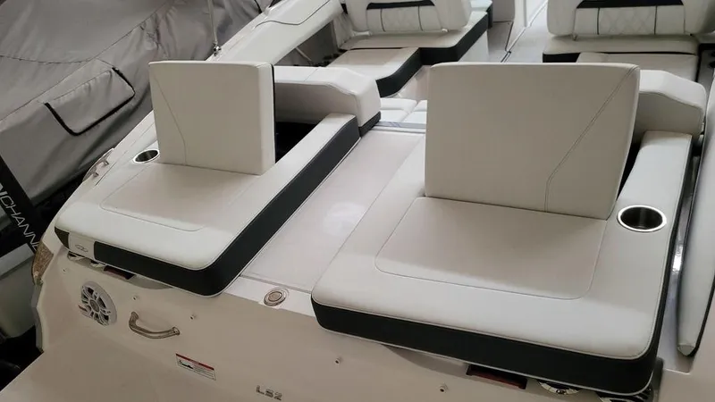 Slide: The Image of 2024 Regal LS2 boat interior with white seating and cup holders. - 4