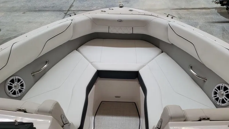 Slide: The Image of 2024 Regal LS2 boat interior with white cushioned seating and built-in speakers. - 5