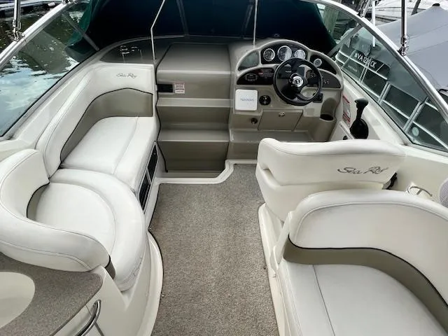 Slide: The Image of 2005 Sea Ray 260 Sundancer boat interior with helm and seating. - 11