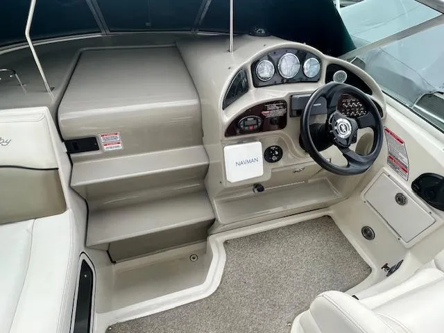 Slide: The Image of 2005 Sea Ray 260 Sundancer helm with steering wheel and instrument panel. - 13