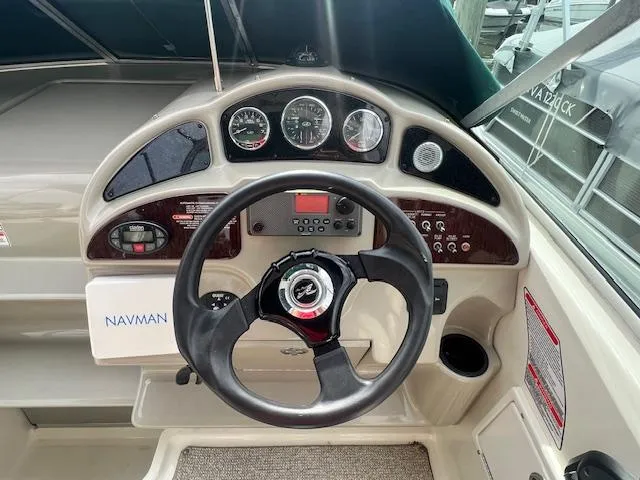 Slide: The Image of 2005 Sea Ray 260 Sundancer helm with steering wheel and instrument panel. - 19
