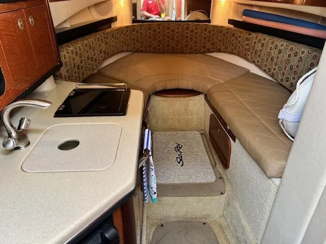Slide: The Image of Interior cabin of a 2005 Sea Ray 260 Sundancer boat with kitchenette and seating area. - 21