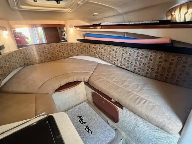 Slide: The Image of Interior cabin of a 2005 Sea Ray 260 Sundancer boat with cushioned seating. - 23