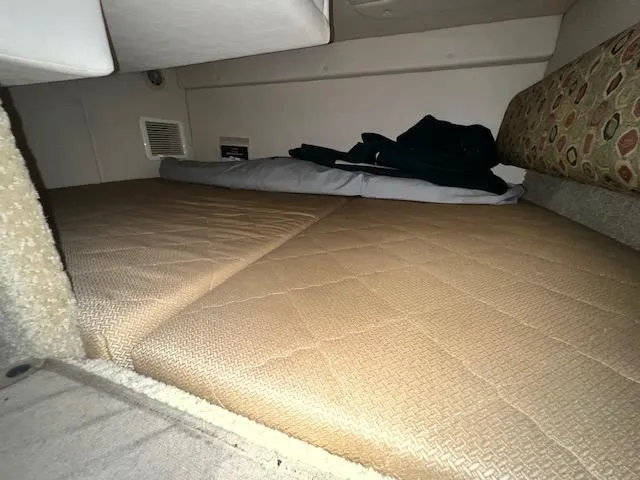 Slide: The Image of Interior sleeping area of 2005 Sea Ray 260 Sundancer boat with beige mattress. - 25