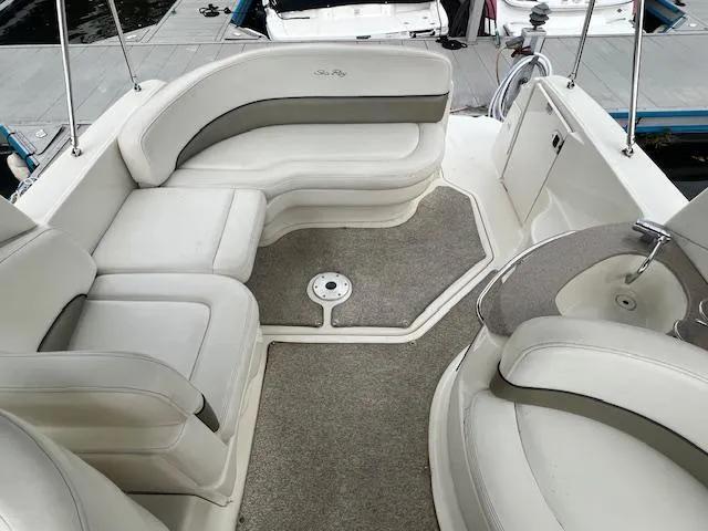 Slide: The Image of 2005 Sea Ray 260 Sundancer boat interior with white seating and carpeted floor. - 7