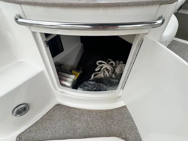 Slide: The Image of Storage compartment on a 2005 Sea Ray 260 Sundancer boat with ropes and supplies. - 9
