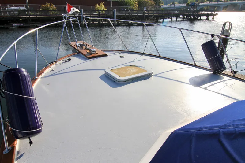 Slide: The Image of 1977 Hatteras 37 Convertible boat deck with railing and water view. - 12