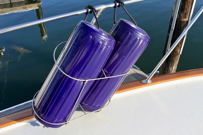 Slide: The Image of Purple boat fenders on a 1977 Hatteras 37 Convertible yacht. - 18