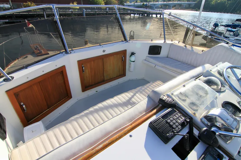 Slide: The Image of 1977 Hatteras 37 Convertible boat cockpit with seating and control panel. - 24