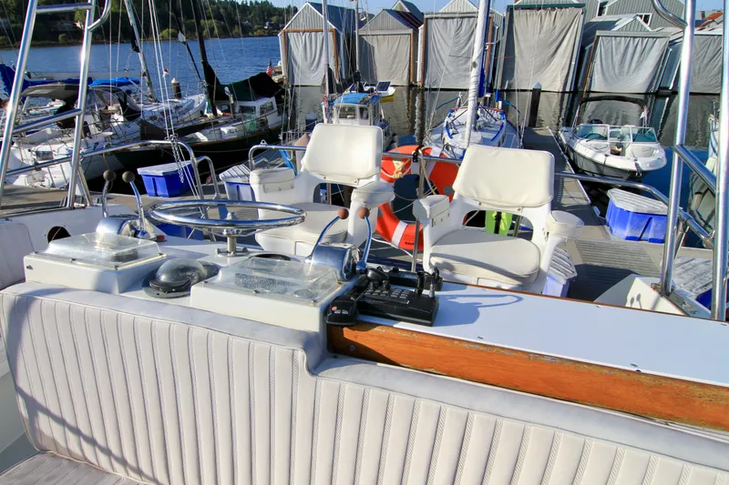 Slide: The Image of 1977 Hatteras 37 Convertible yacht cockpit with helm and seating at marina. - 27