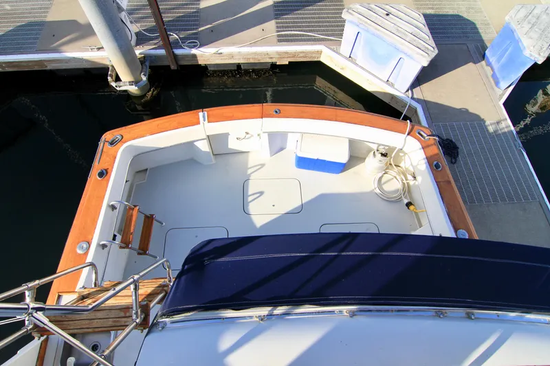 Slide: The Image of 1977 Hatteras 37 Convertible boat deck at the marina. - 32