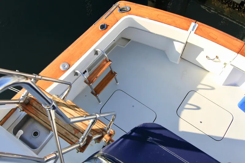 Slide: The Image of 1977 Hatteras 37 Convertible boat deck with wooden ladder and seating. - 33