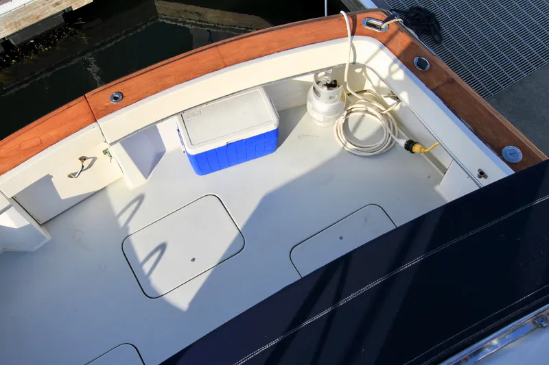 Slide: The Image of 1977 Hatteras 37 Convertible boat deck with storage compartments and cooler. - 34