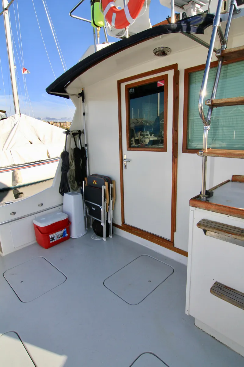 Slide: The Image of 1977 Hatteras 37 Convertible boat deck with door and stairs. - 41