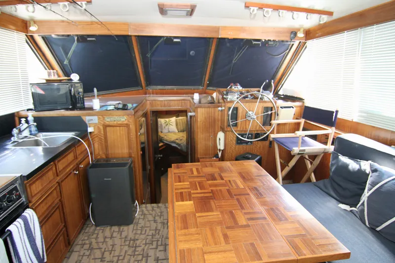 Slide: The Image of 1977 Hatteras 37 Convertible yacht interior with wooden furnishings and helm station. - 47
