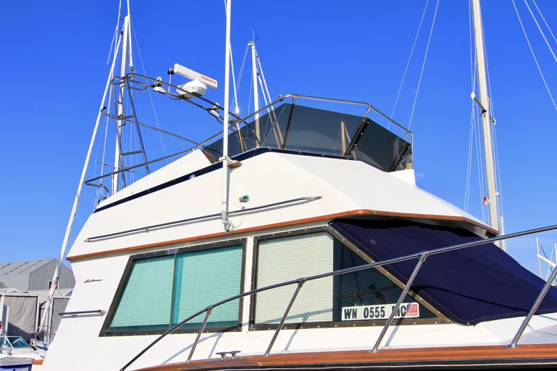 Slide: The Image of 1977 Hatteras 37 Convertible yacht docked at marina. - 5