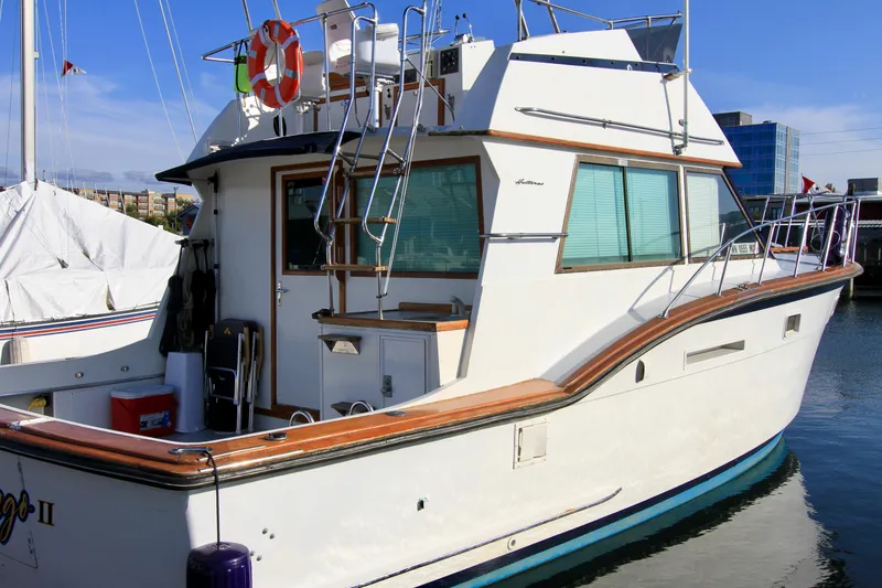 Slide: The Image of 1977 Hatteras 37 Convertible yacht docked at marina. - 6