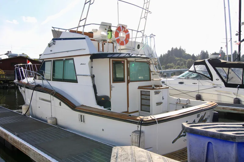 Slide: The Image of 1977 Hatteras 37 Convertible yacht docked at marina. - 8