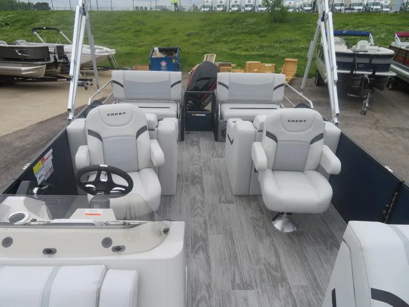 Slide: The Image of 2024 Crest Classic LX 240 SLRC pontoon boat with spacious seating and modern design. - 5