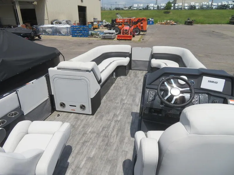 Slide: The Image of 2024 Crest Caribbean RS 250 SLS pontoon boat interior with modern seating and steering console. - 5
