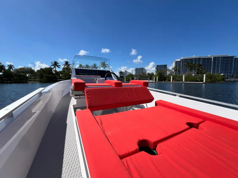 Slide: The Image of Goldfish 23 Tender 2021 boat with red seating, cruising on a sunny day. - 13