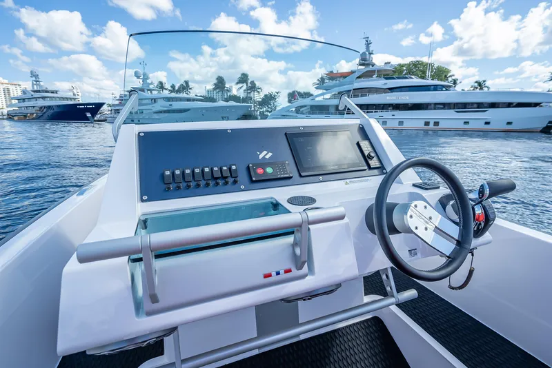 Slide: The Image of Control panel of a 2021 Goldfish 23 Tender boat docked at a marina. - 18