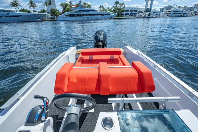 Slide: The Image of 2021 Goldfish 23 Tender boat with red seating on a sunny day. - 24