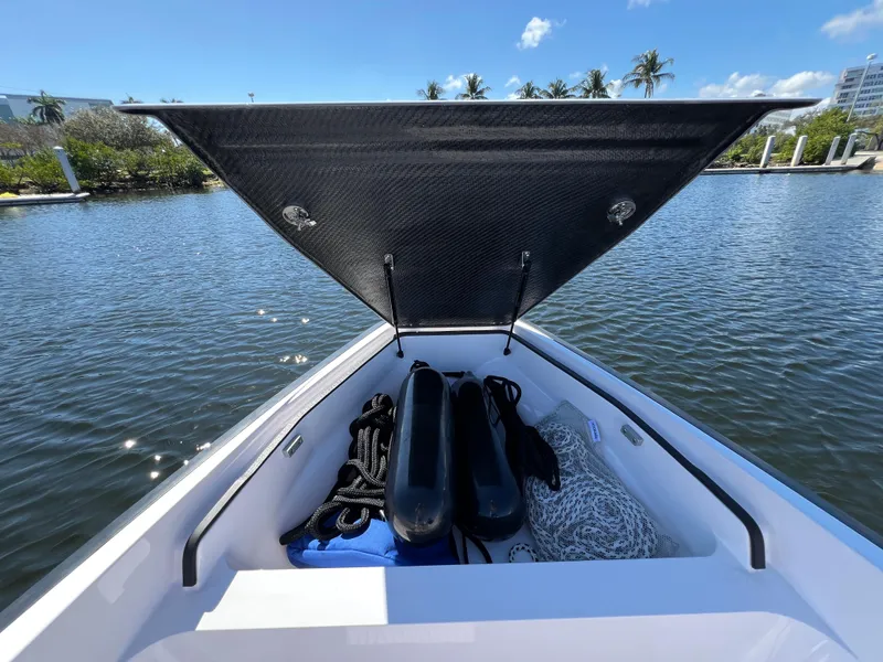 Slide: The Image of Open storage compartment on 2021 Goldfish 23 Tender boat, with ropes and fenders. - 29