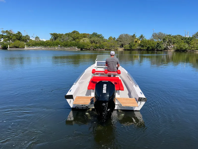 Slide: The Image of Man driving 2021 Goldfish 23 Tender boat on calm lake. - 3