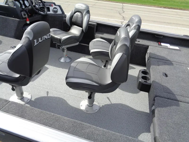 Slide: The Image of 2024 Lund 1875 Impact XS SS boat interior with swivel seats and console. - 5