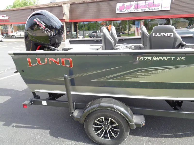 Slide: The Image of 2024 Lund 1875 Impact XS SS boat on trailer, side view. - 8
