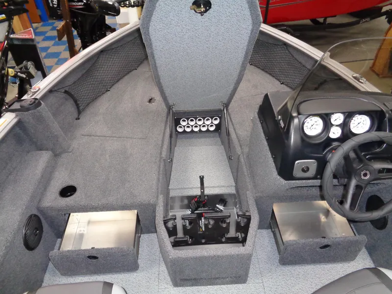 Slide: The Image of 2024 Lund 1875 Impact XS SS boat interior with gray carpet and control panel. - 16