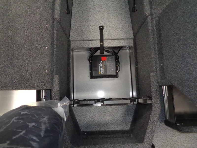 Slide: The Image of 2024 Lund 1875 Impact XS SS boat interior with storage compartments and control console. - 17