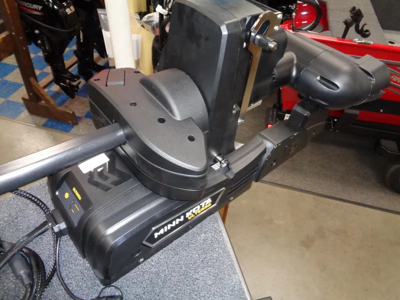 Slide: The Image of 2024 Lund 1875 Impact XS SS boat interior with gray seating and trolling motor. - 20