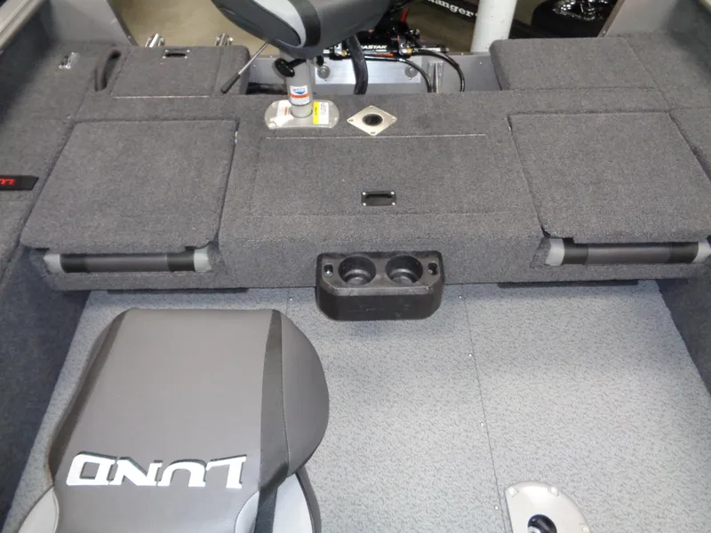 Slide: The Image of 2024 Lund 1875 Impact XS SS boat interior with four seats and steering console. - 22