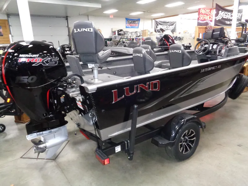 Slide: The Image of 2024 Lund 1875 Impact XS SS boat on trailer in showroom. - 3