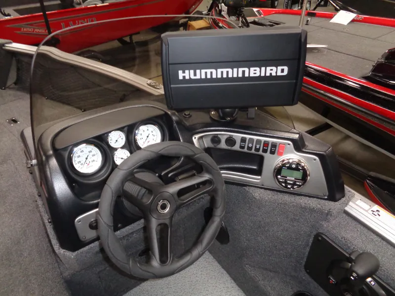 Slide: The Image of 2024 Lund 1875 Impact XS SS boat interior with seating and storage compartments. - 30