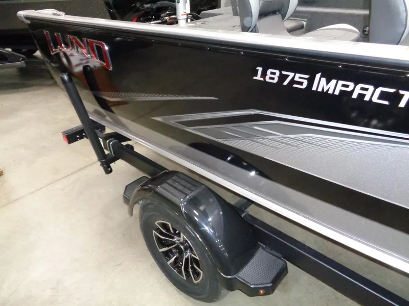 Slide: The Image of 2024 Lund 1875 Impact XS SS boat interior with seating and storage compartments. - 5