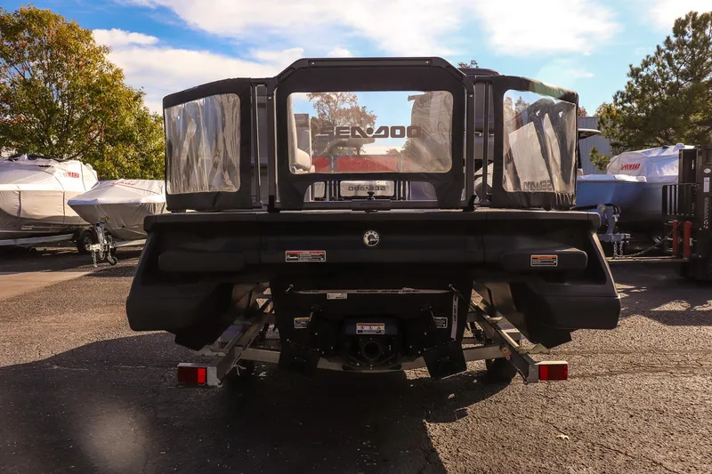 Slide: The Image of 2024 Sea-Doo Switch 16 pontoon boat rear view in a sunny outdoor setting. - 3