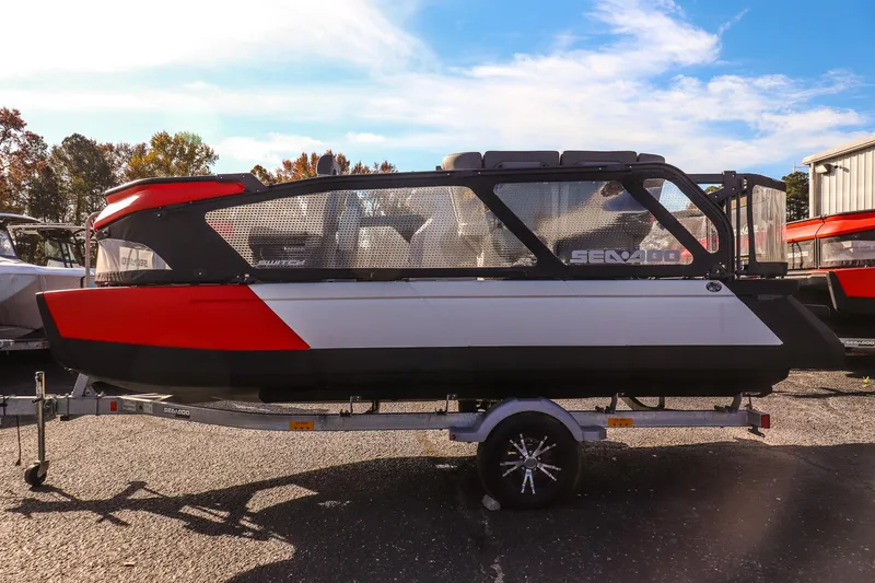 Slide: The Image of 2024 Sea-Doo Switch 16 pontoon boat on trailer, featuring sleek red and black design. - 5