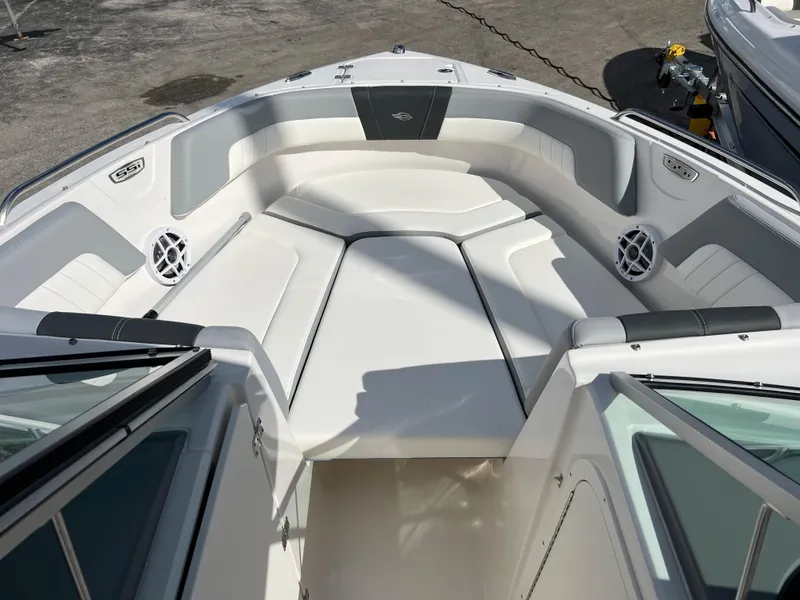 Slide: The Image of 2023 Chaparral 23 SSi OB boat interior with white cushioned seating. - 10