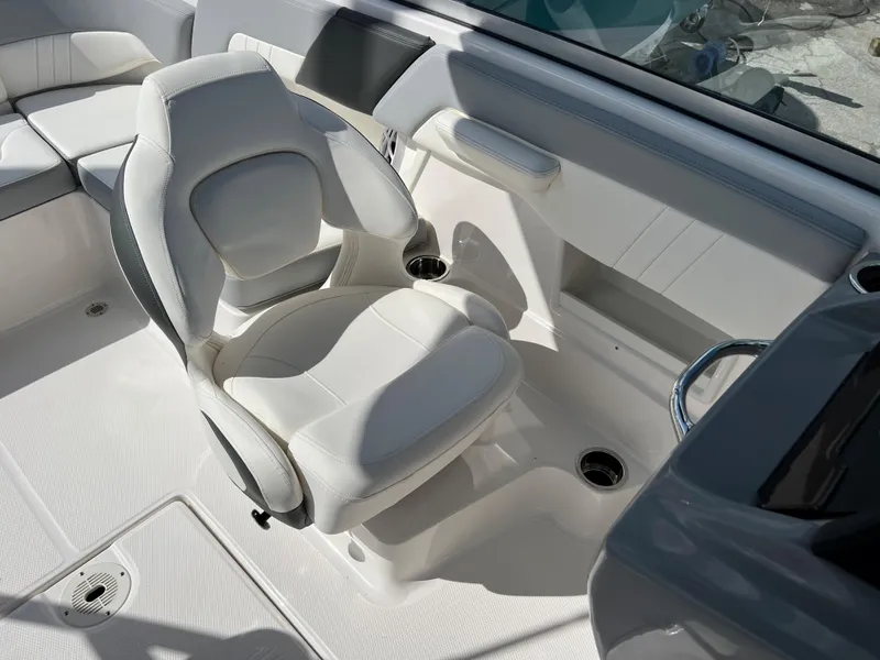 Slide: The Image of 2023 Chaparral 23 SSi OB boat interior with white captain's chair and seating area. - 13