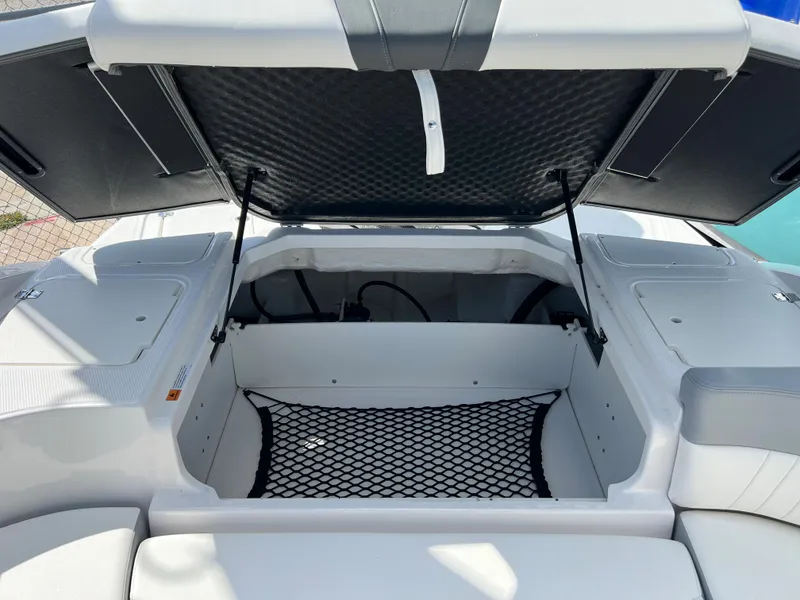 Slide: The Image of 2023 Chaparral 23 SSi OB boat storage compartment with open hatch. - 14