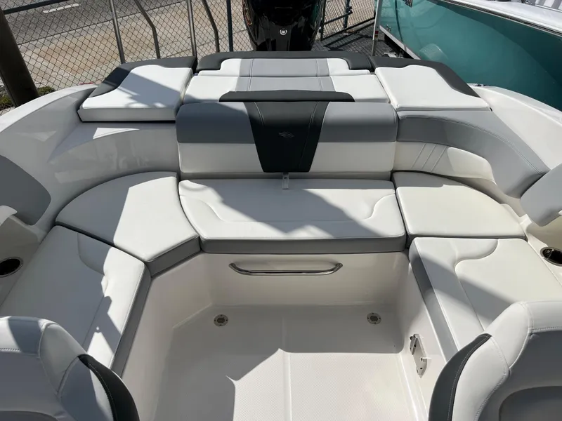 Slide: The Image of 2023 Chaparral 23 SSi OB boat interior with white and gray seating. - 15