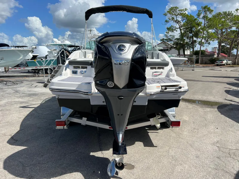 Slide: The Image of 2023 Chaparral 23 SSi OB boat with outboard motor, parked on a trailer. - 3