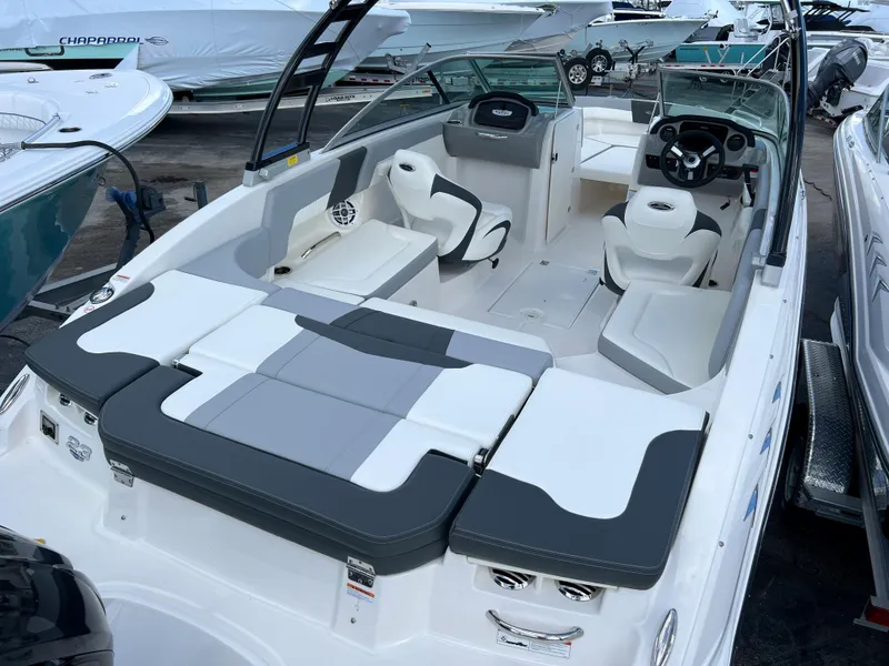 Slide: The Image of 2023 Chaparral 23 SSi OB boat interior with seating and steering console. - 4