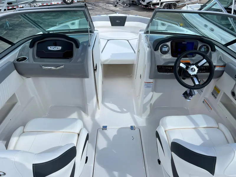 Slide: The Image of 2023 Chaparral 23 SSi OB boat interior with dual helm seats and modern dashboard. - 7