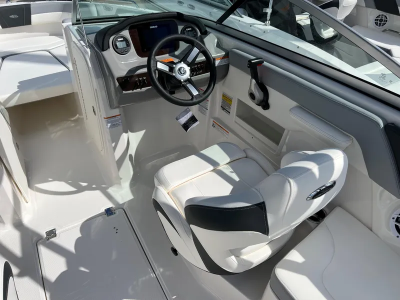 Slide: The Image of 2023 Chaparral 23 SSi OB boat cockpit with steering wheel and captain's chair. - 8
