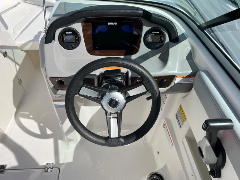 Slide: The Image of 2023 Chaparral 23 SSi OB boat dashboard with steering wheel and controls. - 9