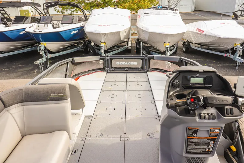 Slide: The Image of 2024 Sea-Doo Switch Sport 21 interior with control panel, docked boats in background. - 17